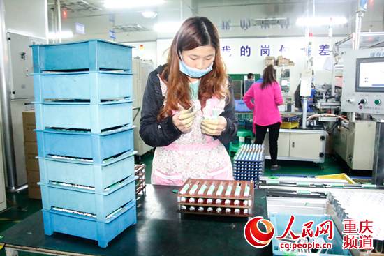 中欣维动力一名员工正在流水线上操作，生产锂离子动力电池
